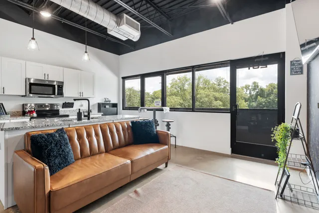a view of living room kitchen with furniture and a potted plant