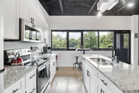 a kitchen that has a sink and a stove