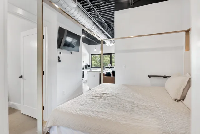 a large white bed in a white room