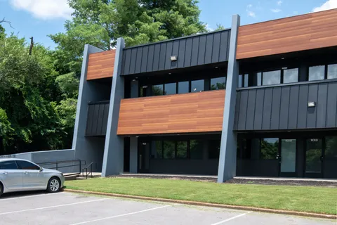 a view of a car park in front of a house