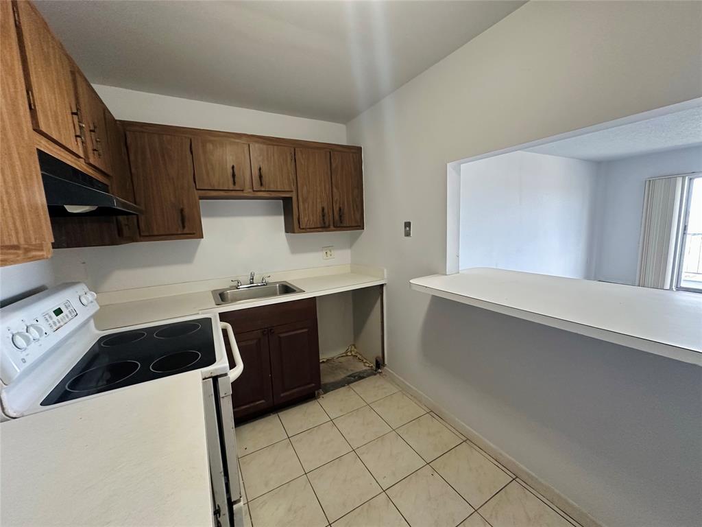 4174 Inverrary Drive, Unit 805 Lauderhill, FL 33319 - Photo 14 of 26 a kitchen with a cabinets and window
