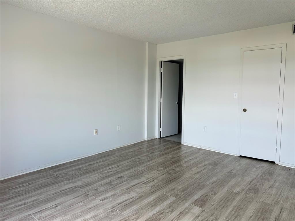 4174 Inverrary Drive, Unit 805 Lauderhill, FL 33319 - Photo 19 of 26 a view of an empty room with wooden floor and closet