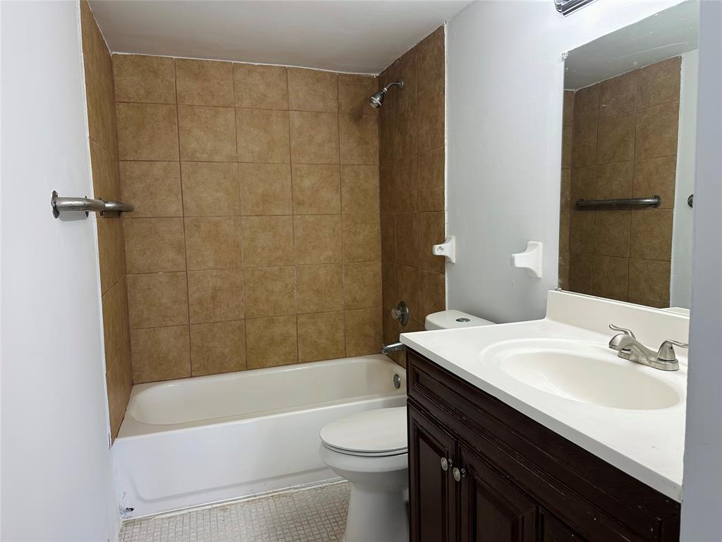 4174 Inverrary Drive, Unit 805 Lauderhill, FL 33319 - Photo 20 of 26 a bathroom with a sink a toilet and shower