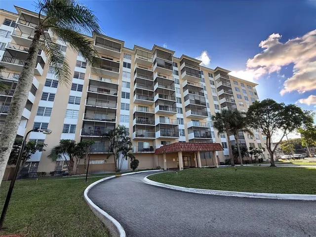 a view of a tall building with a yard