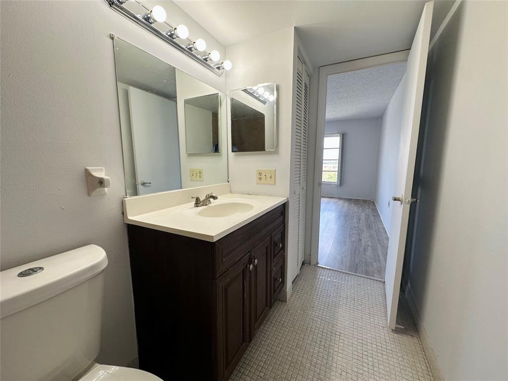 4174 Inverrary Drive, Unit 805 Lauderhill, FL 33319 - Photo 21 of 26 a bathroom with a double vanity sink and a mirror