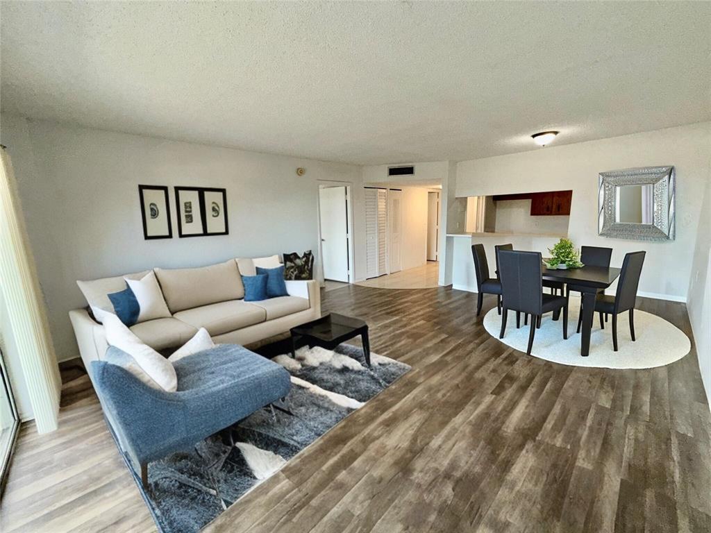 4174 Inverrary Drive, Unit 805 Lauderhill, FL 33319 - Photo 3 of 26 a living room with furniture and a wooden floor