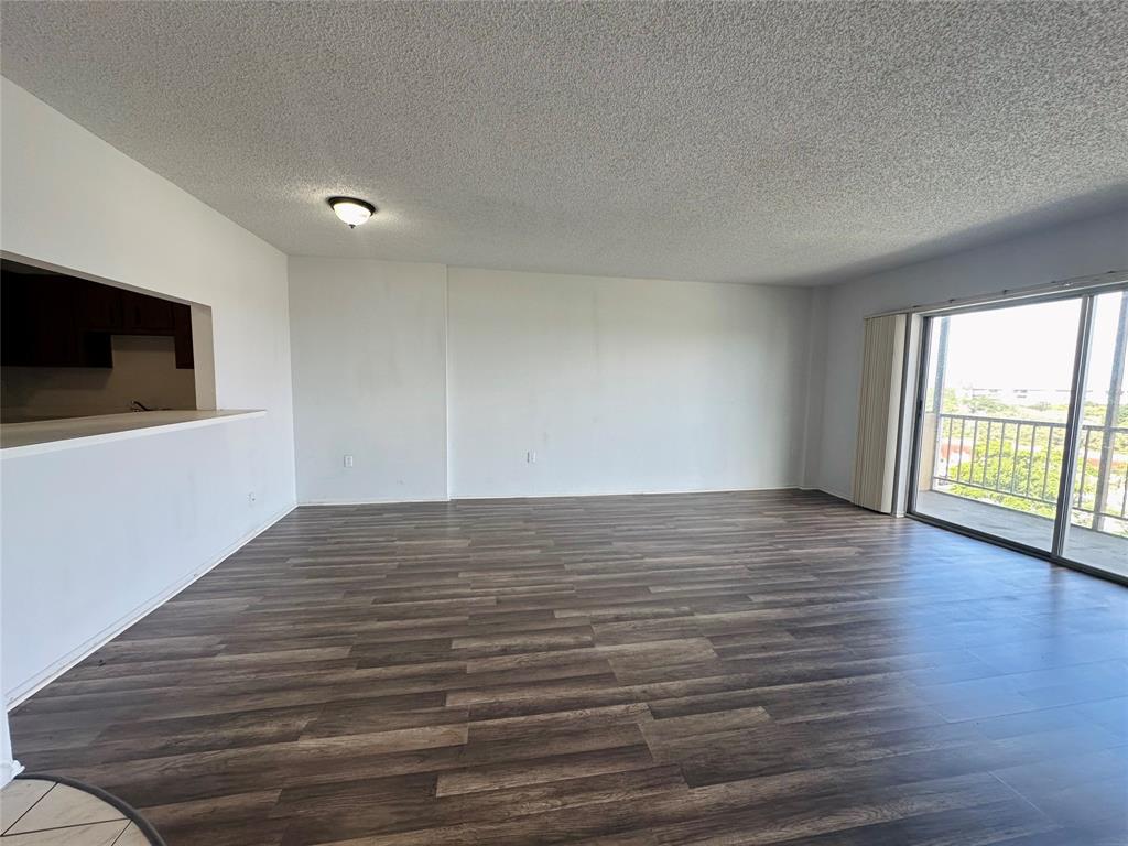 4174 Inverrary Drive, Unit 805 Lauderhill, FL 33319 - Photo 6 of 26 a view of a livingroom with wooden floor and a flat screen tv
