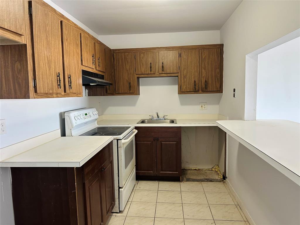 4174 Inverrary Drive, Unit 805 Lauderhill, FL 33319 - Photo 10 of 26 a kitchen with a sink cabinets and appliances