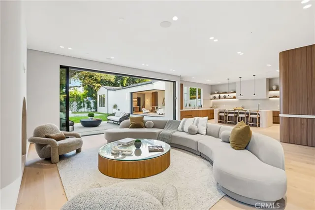 a view of a kitchen with kitchen island a sink a counter space and a stove