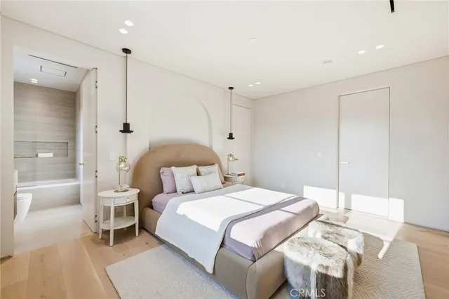 a bedroom with a bed and a painting on the wall