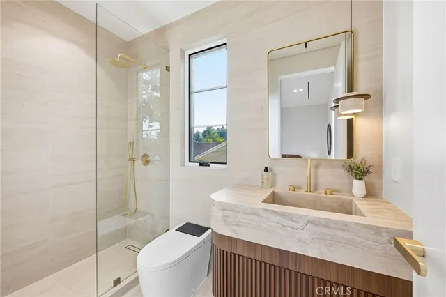 a bathroom with a sink a toilet and a mirror