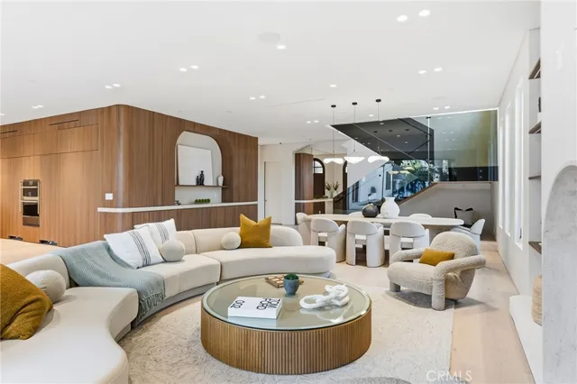 a living room with furniture and a kitchen view