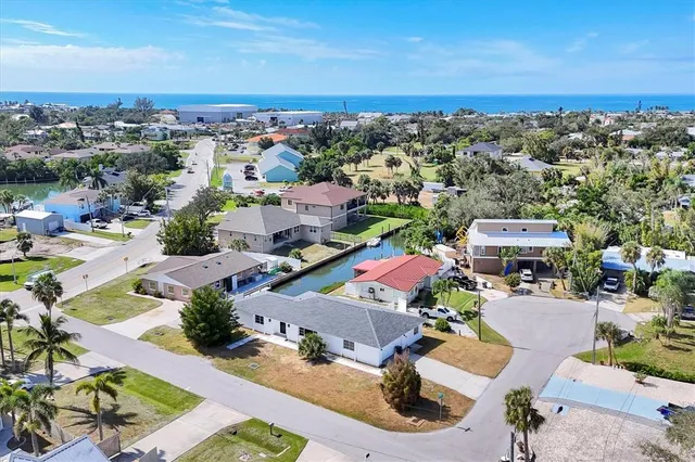 an aerial view of a houses with a city view