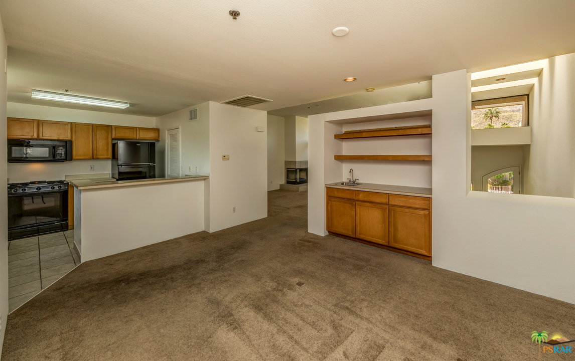 100 East Stevens Road, Unit 513 Palm Springs, CA 92262 - Photo 13 of 39 a kitchen with a refrigerator and a stove top oven