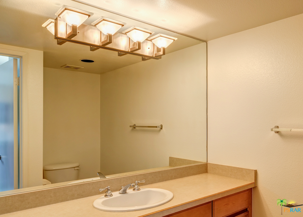 100 East Stevens Road, Unit 513 Palm Springs, CA 92262 - Photo 17 of 39 a bathroom with a sink and mirror