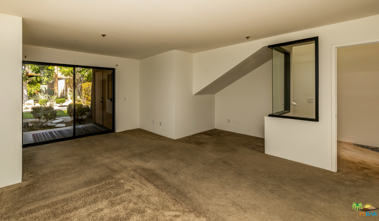 100 East Stevens Road, Unit 513 Palm Springs, CA 92262 - Photo 20 of 39 a view of an empty room with wooden floor and a window