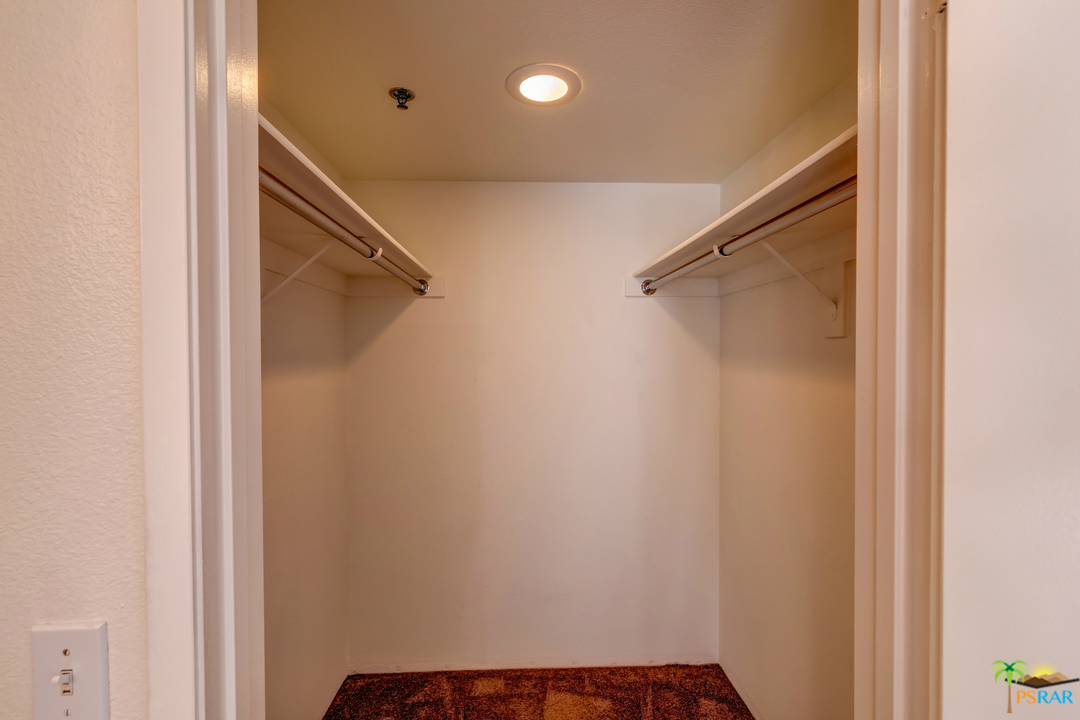 100 East Stevens Road, Unit 513 Palm Springs, CA 92262 - Photo 31 of 39 a view of walk in closet with clothes and shoes