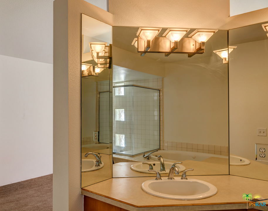 100 East Stevens Road, Unit 513 Palm Springs, CA 92262 - Photo 32 of 39 a bathroom with a sink and a mirror