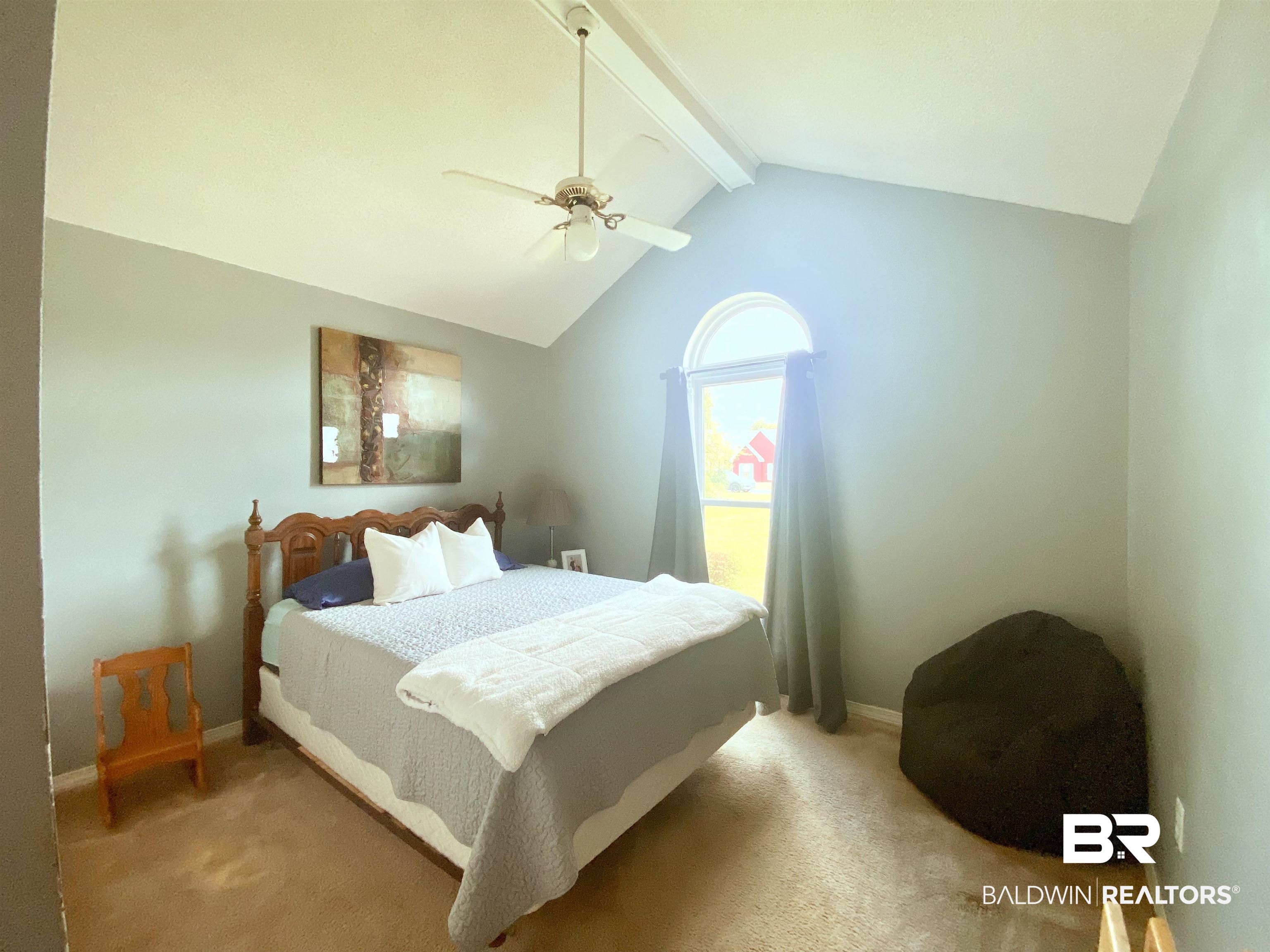 2 Windgate Court Foley, AL 36535 - Photo 12 of 28 Bedroom with vaulted ceiling with beams, carpet, and ceiling fan