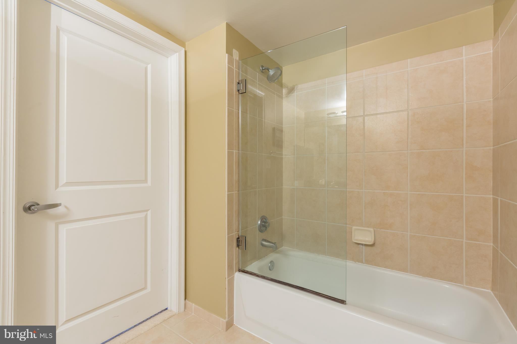 915 E Street Northwest, Unit 613 Washington, DC 20004 - Photo 11 of 30 a bathroom with a bathtub and a shower