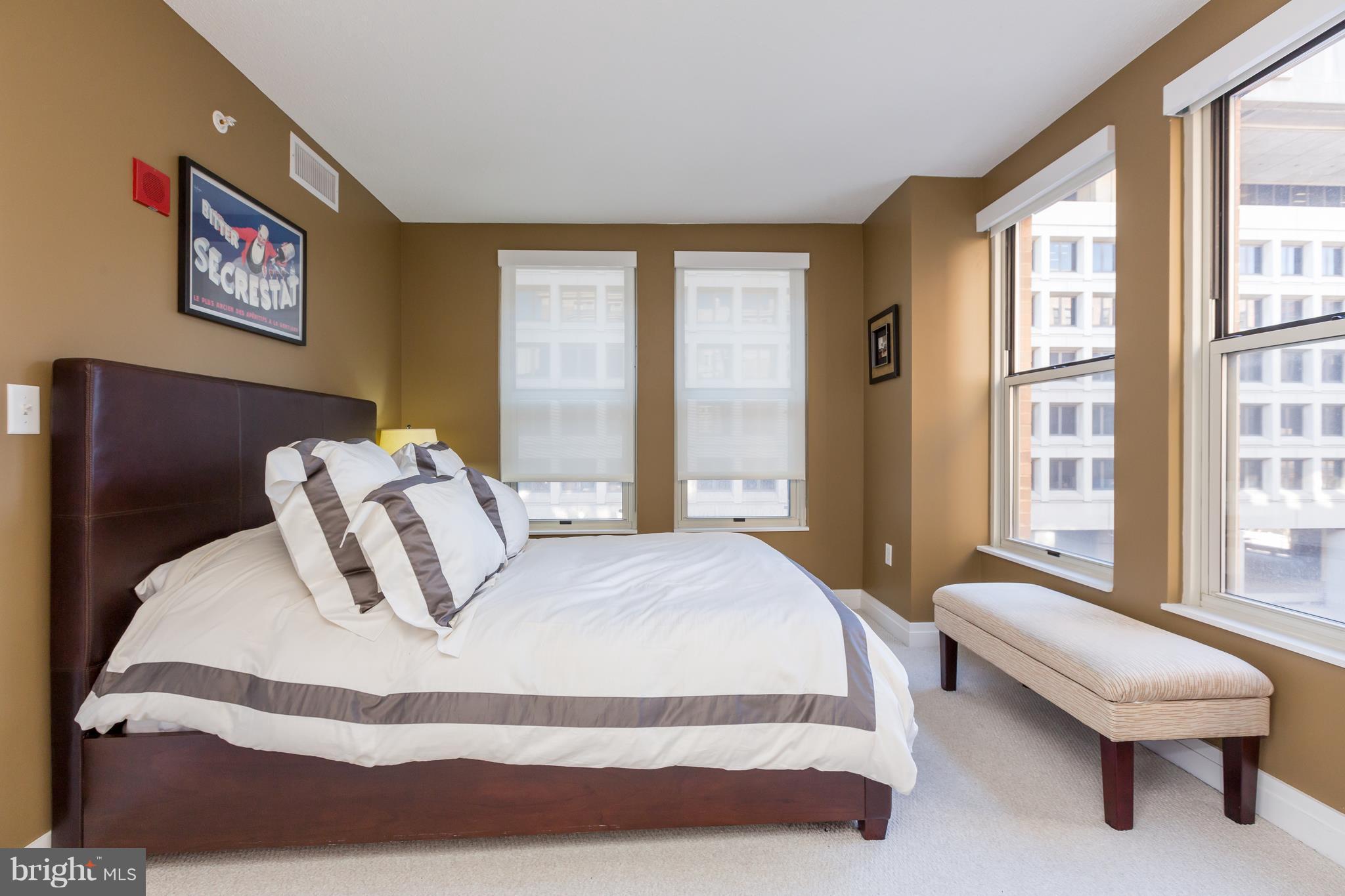 915 E Street Northwest, Unit 613 Washington, DC 20004 - Photo 13 of 30 a bedroom with a large bed and a large window