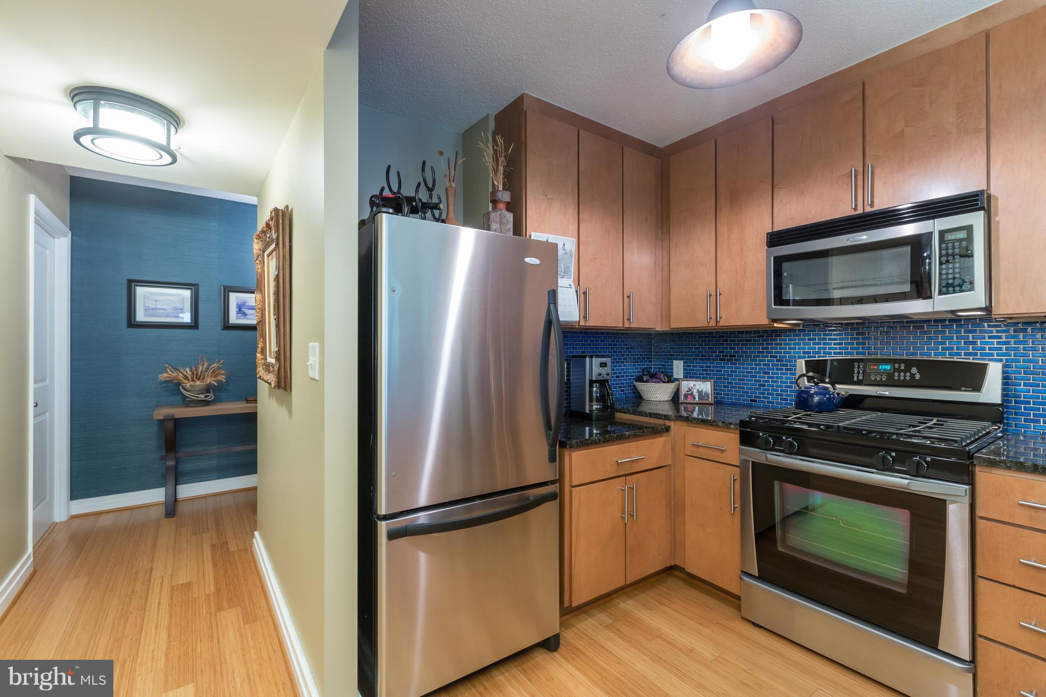 915 E Street Northwest, Unit 613 Washington, DC 20004 - Photo 17 of 30 a kitchen with a refrigerator stove and microwave