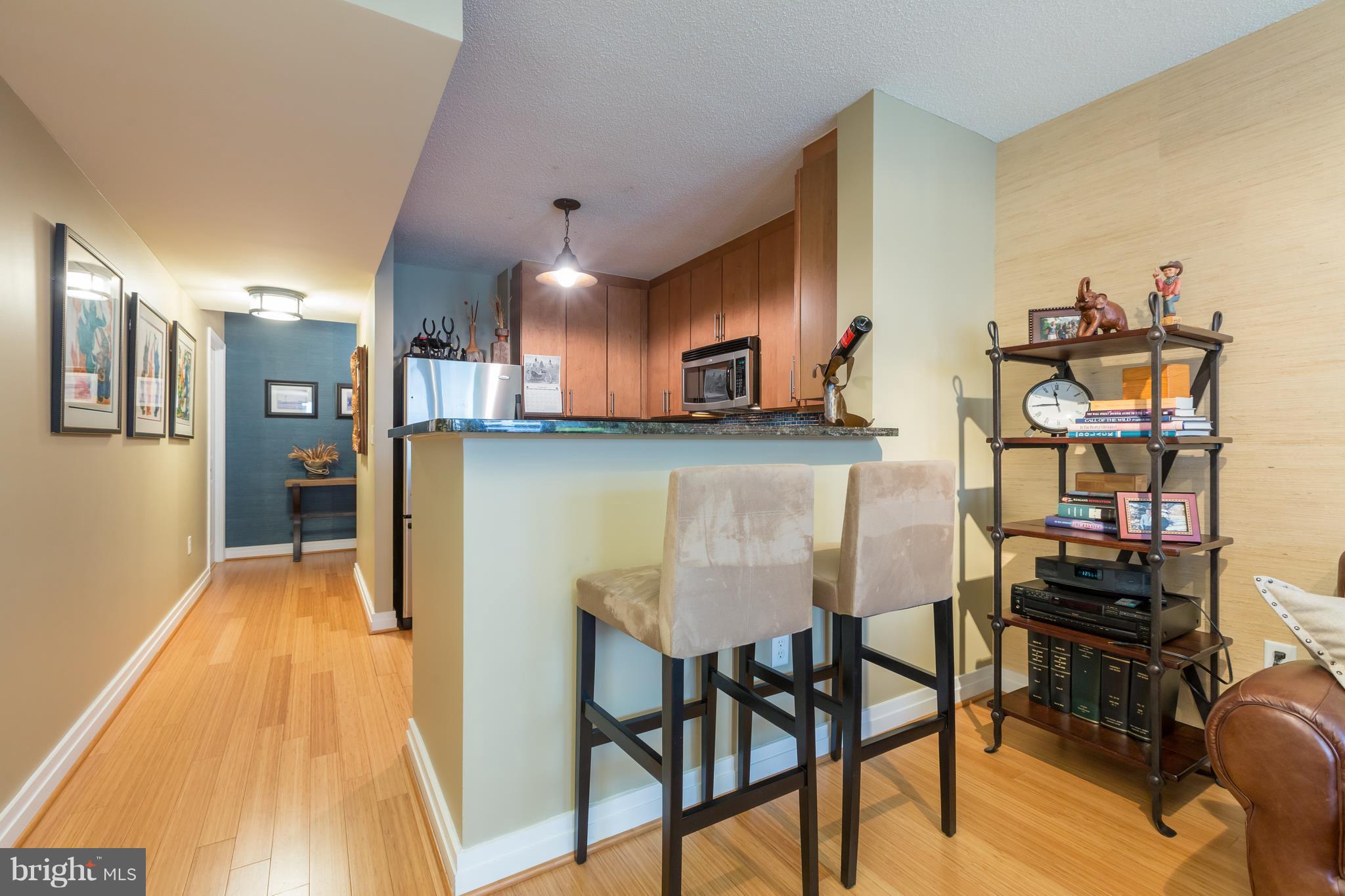 915 E Street Northwest, Unit 613 Washington, DC 20004 - Photo 20 of 30 a kitchen with stainless steel appliances a table and chairs in it