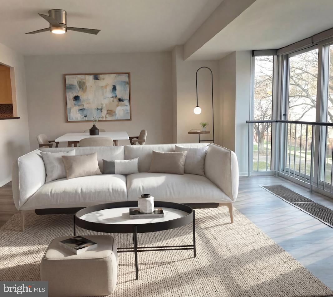 a living room with furniture and a wooden floor