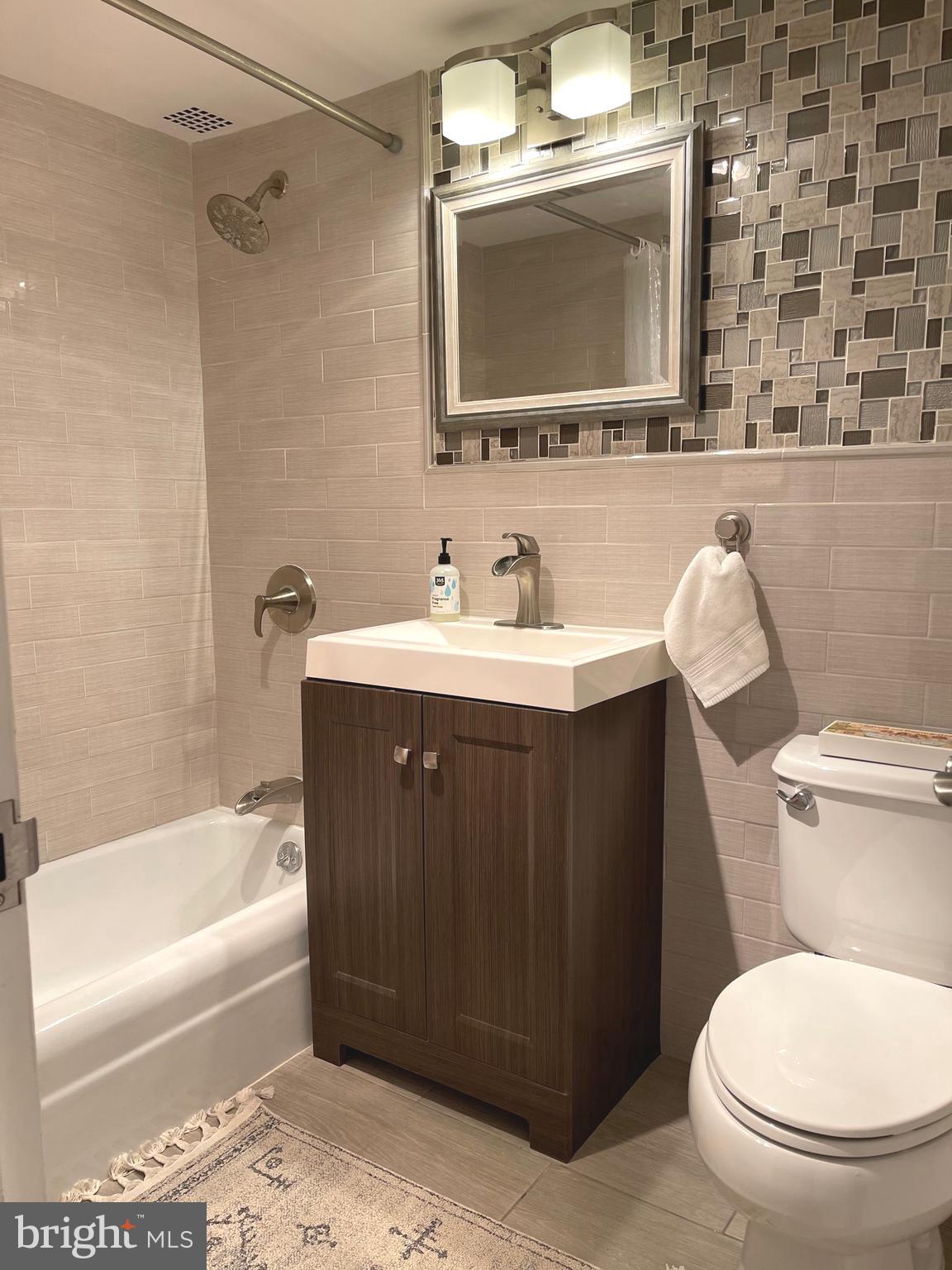 520 N Street Southwest, Unit S317 Washington, DC 20024 - Photo 17 of 64 a bathroom with a sink a toilet and bathtub