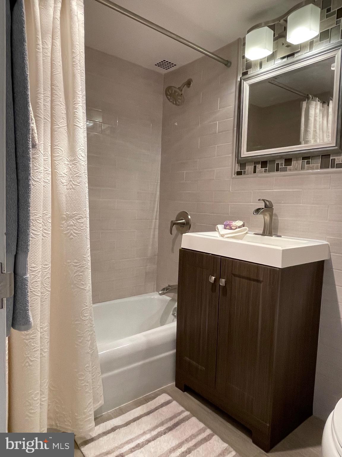 520 N Street Southwest, Unit S317 Washington, DC 20024 - Photo 22 of 64 a bathroom with a sink vanity mirror and bathtub