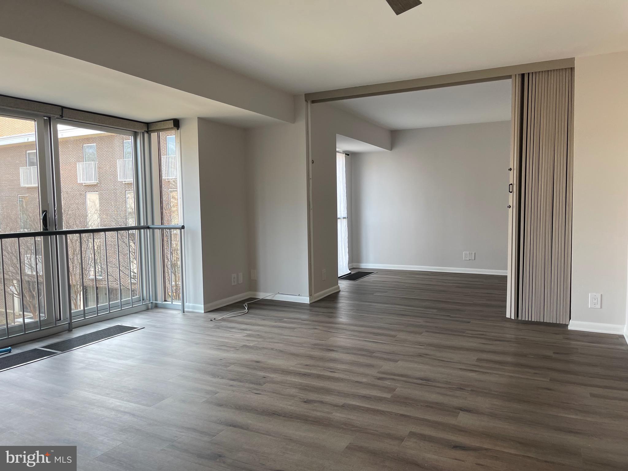 520 N Street Southwest, Unit S317 Washington, DC 20024 - Photo 35 of 64 an empty room with wooden floor and windows