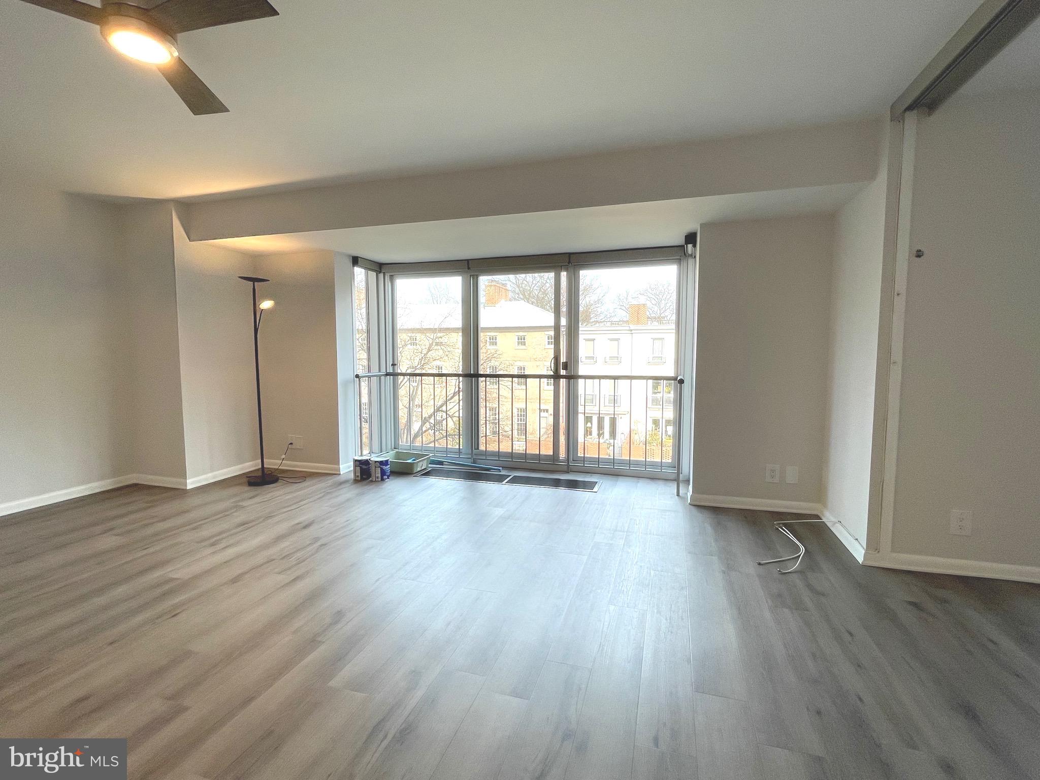 520 N Street Southwest, Unit S317 Washington, DC 20024 - Photo 5 of 64 an empty room with wooden floor and windows