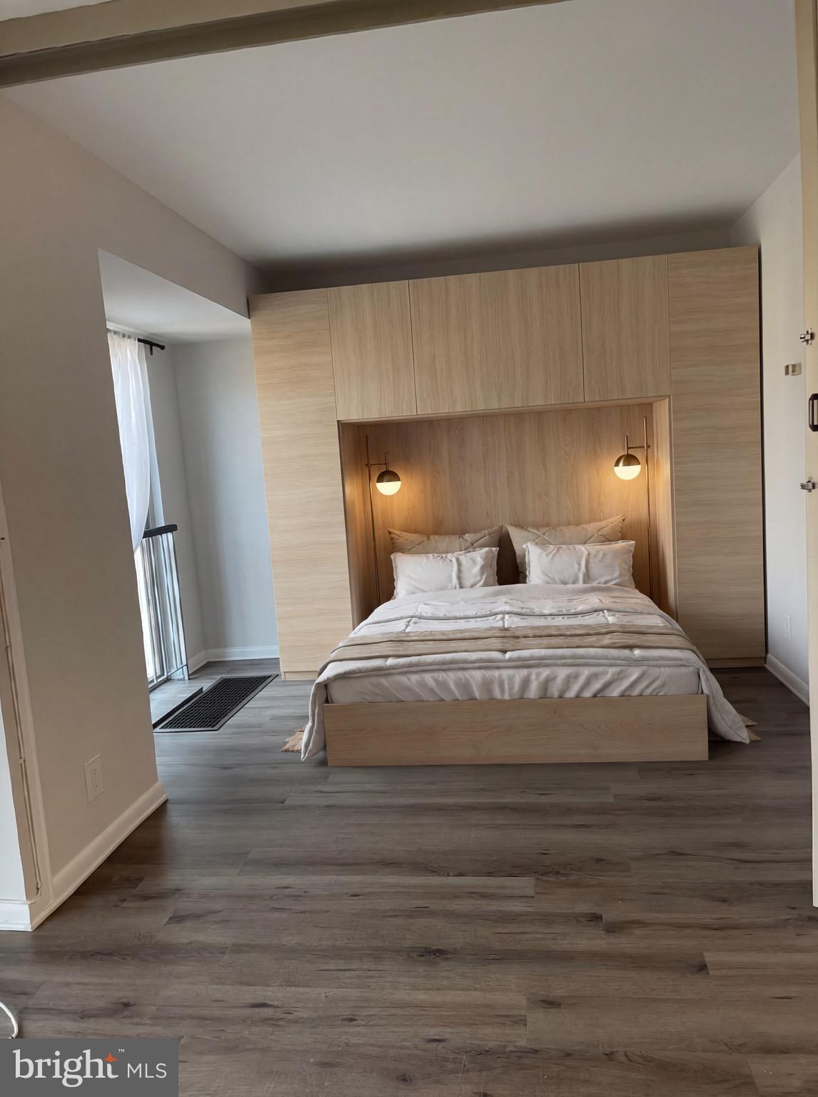 520 N Street Southwest, Unit S317 Washington, DC 20024 - Photo 6 of 64 a bedroom with a bed and wooden floor