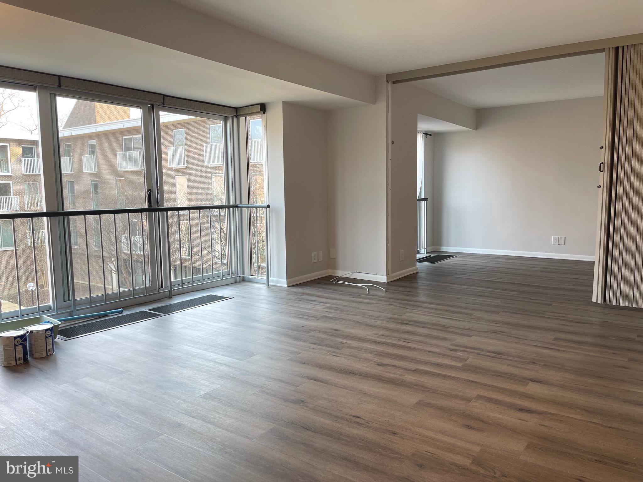 520 N Street Southwest, Unit S317 Washington, DC 20024 - Photo 7 of 64 an empty room with wooden floor and windows