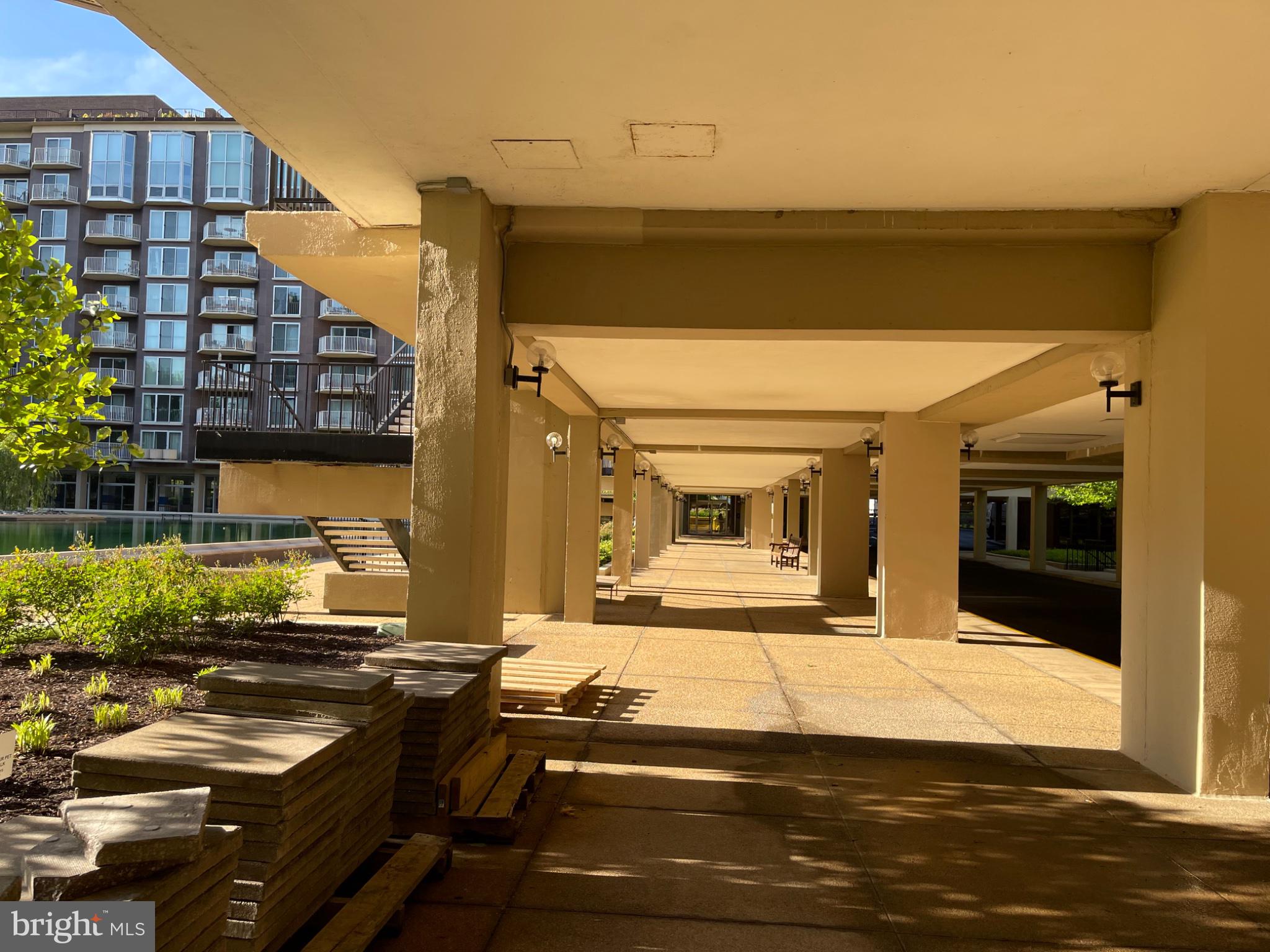 520 N Street Southwest, Unit S317 Washington, DC 20024 - Photo 74 of 74 Sunlit walkway beneath modern architecture.
