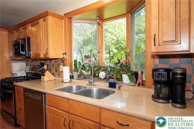 a kitchen with sink a refrigerator and cabinets