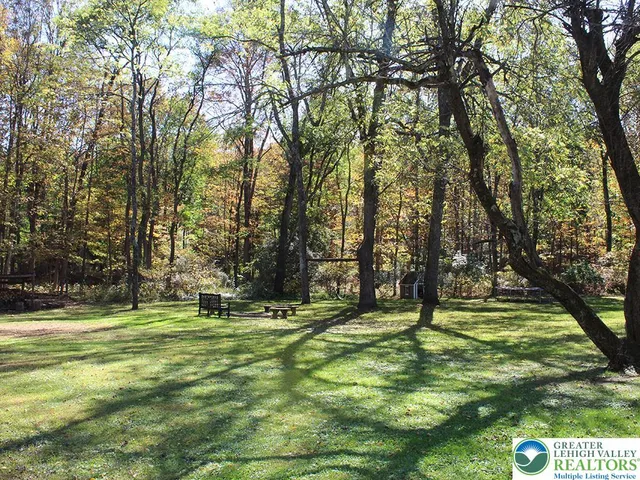 a swimming pool with trees in the background
