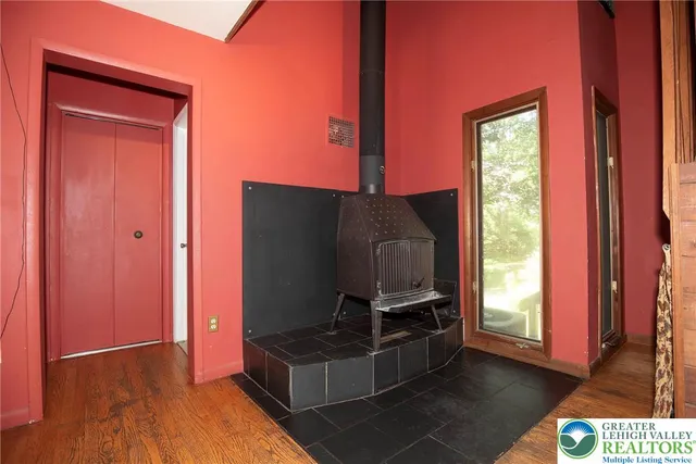 a living room with furniture a flat screen tv and a window