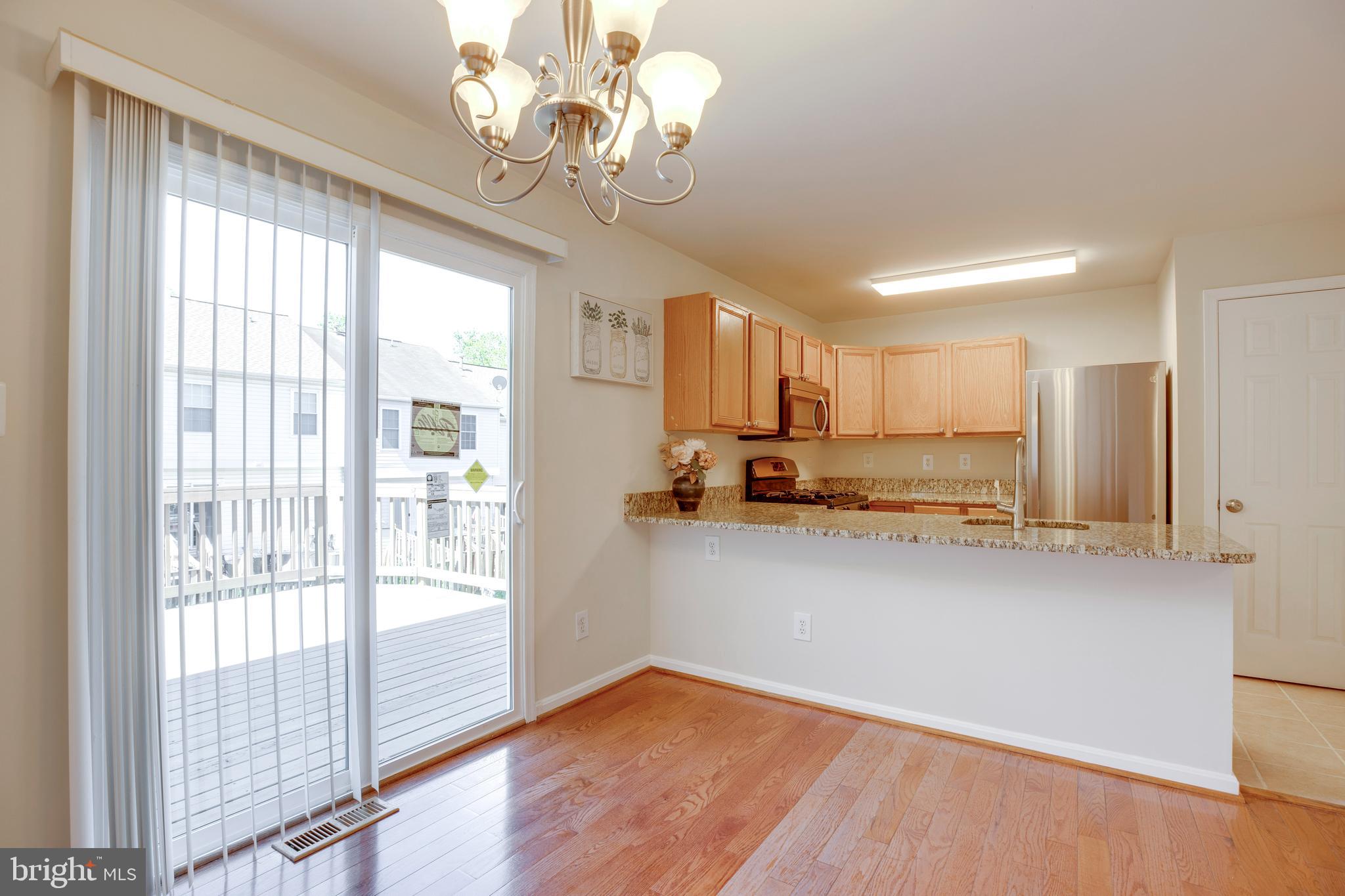 14113 Asher View Centreville, VA 20121 - Photo 11 of 47 a view of a kitchen with a stove wooden floor and a kitchen