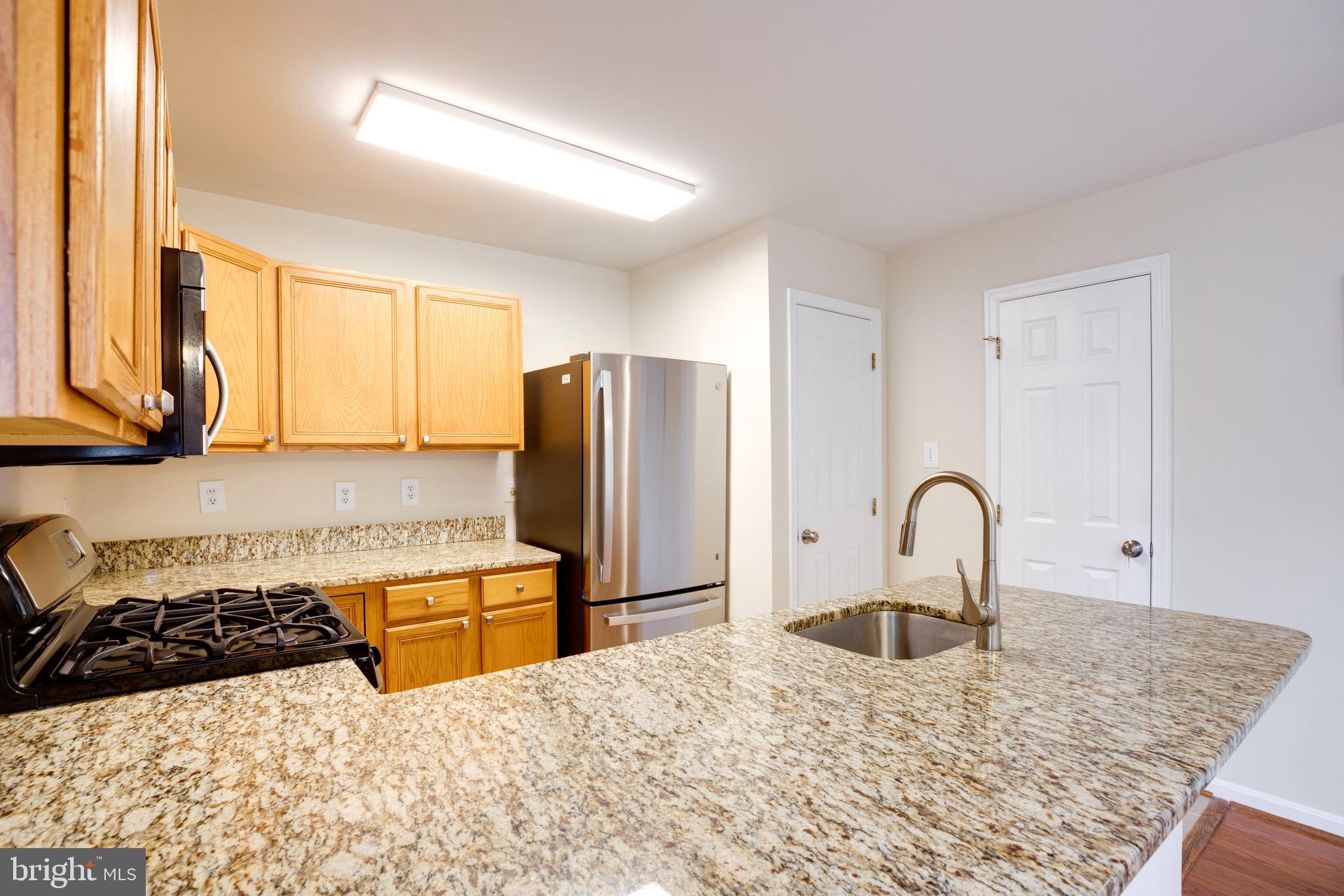 14113 Asher View Centreville, VA 20121 - Photo 13 of 47 a kitchen with a stove a refrigerator and a sink