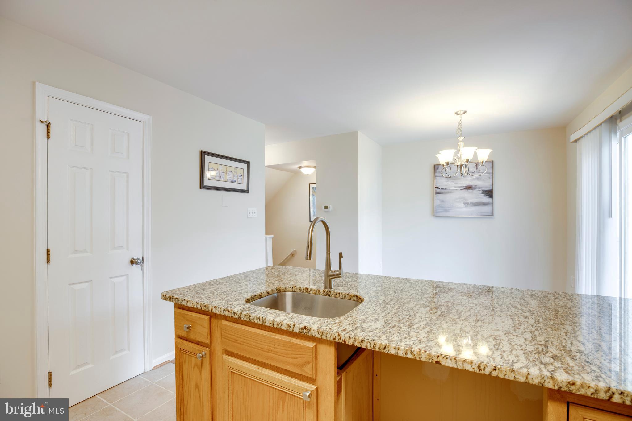 14113 Asher View Centreville, VA 20121 - Photo 18 of 47 a kitchen with kitchen island granite countertop a sink and cabinets
