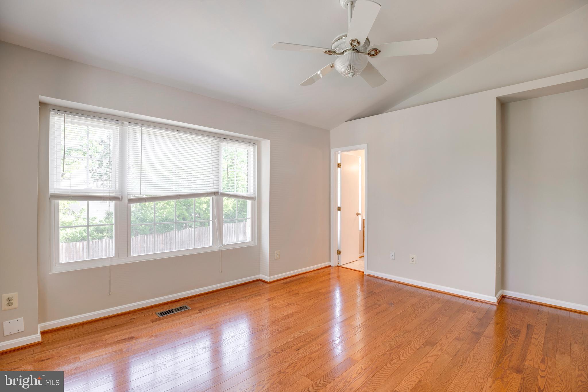 14113 Asher View Centreville, VA 20121 - Photo 20 of 47 an empty room with wooden floor ceiling fan and windows