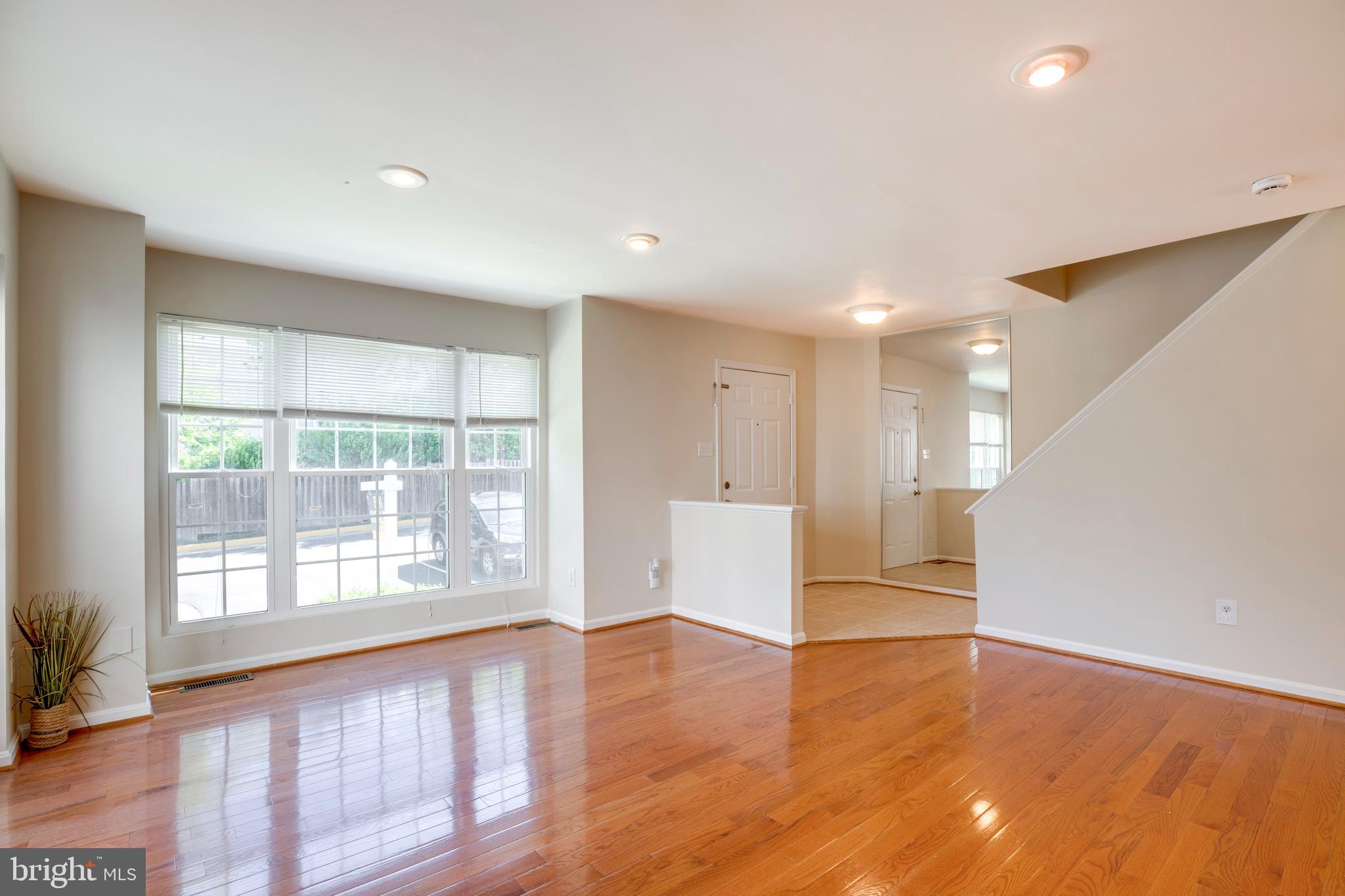 14113 Asher View Centreville, VA 20121 - Photo 3 of 47 a view of an empty room with wooden floor and a window