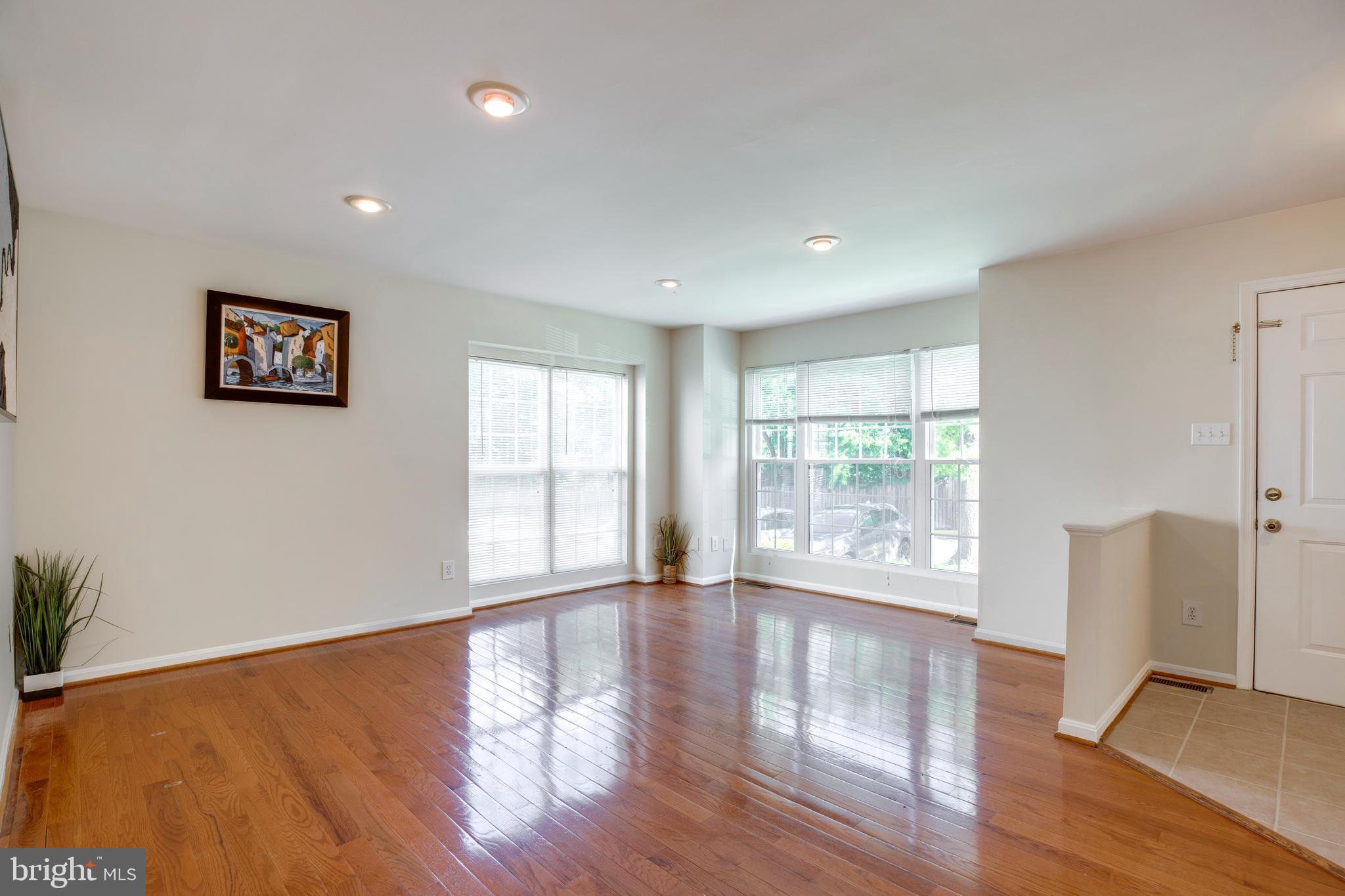 14113 Asher View Centreville, VA 20121 - Photo 4 of 47 a view of an empty room with wooden floor and a window