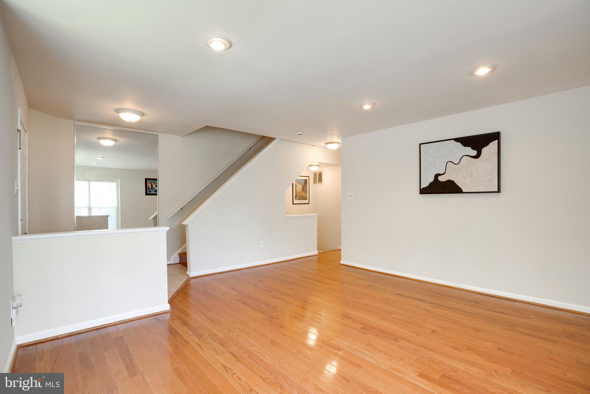 14113 Asher View Centreville, VA 20121 - Photo 5 of 47 a view of a big room with wooden floor and windows