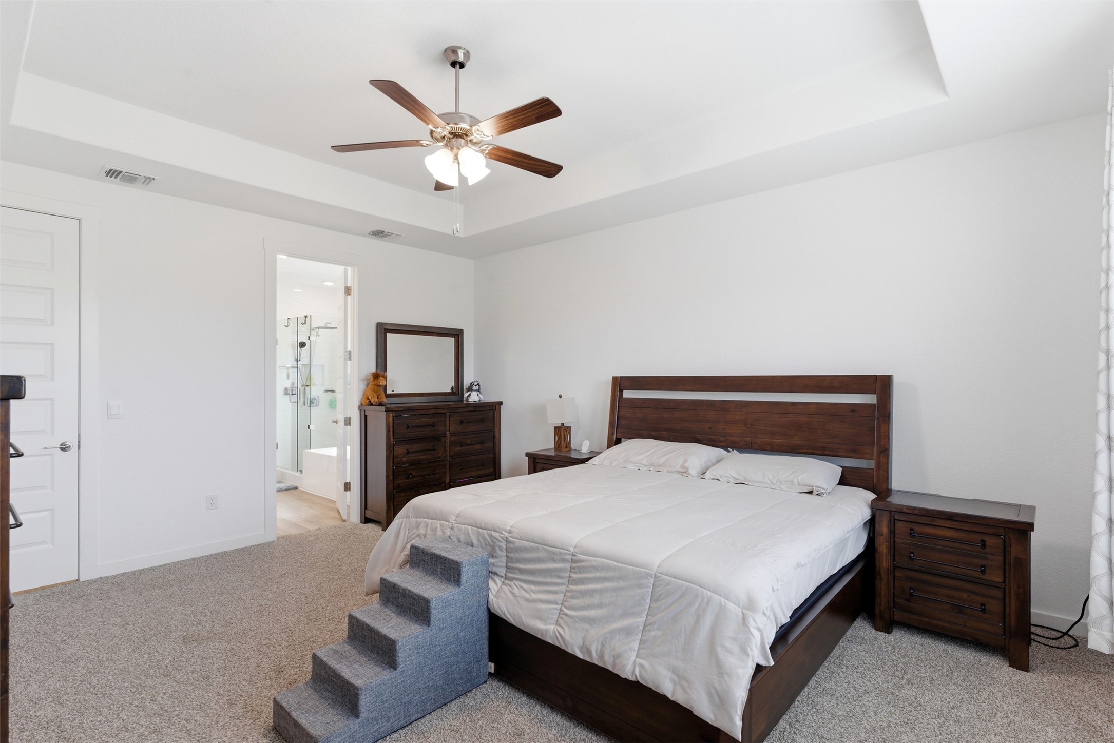 105 Nuntree Cove Georgetown, TX 78628 - Photo 12 of 31 a bedroom with a bed and a chandelier
