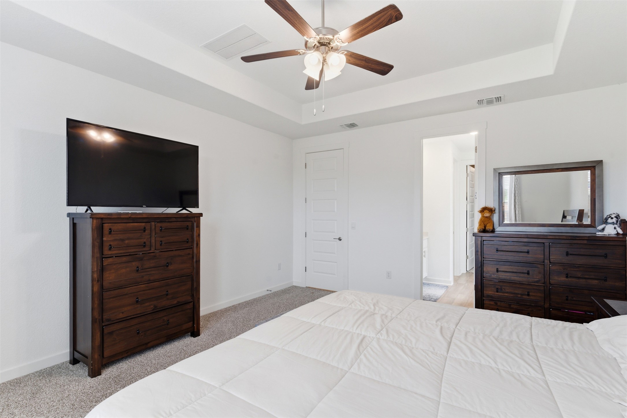 105 Nuntree Cove Georgetown, TX 78628 - Photo 13 of 31 a bedroom with a bed and a flat screen tv