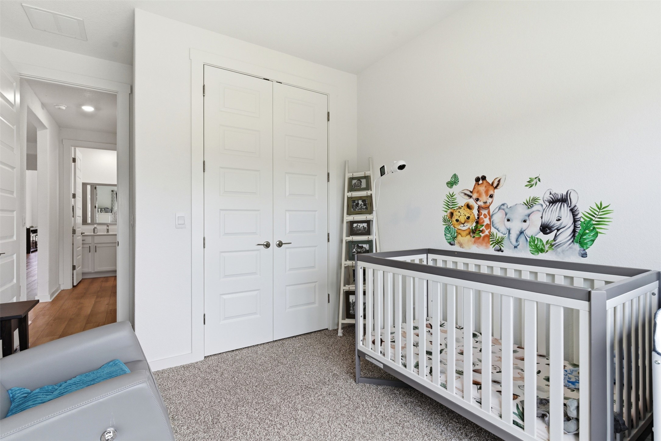 105 Nuntree Cove Georgetown, TX 78628 - Photo 17 of 31 a view of a bedroom with baby crib and wooden floor
