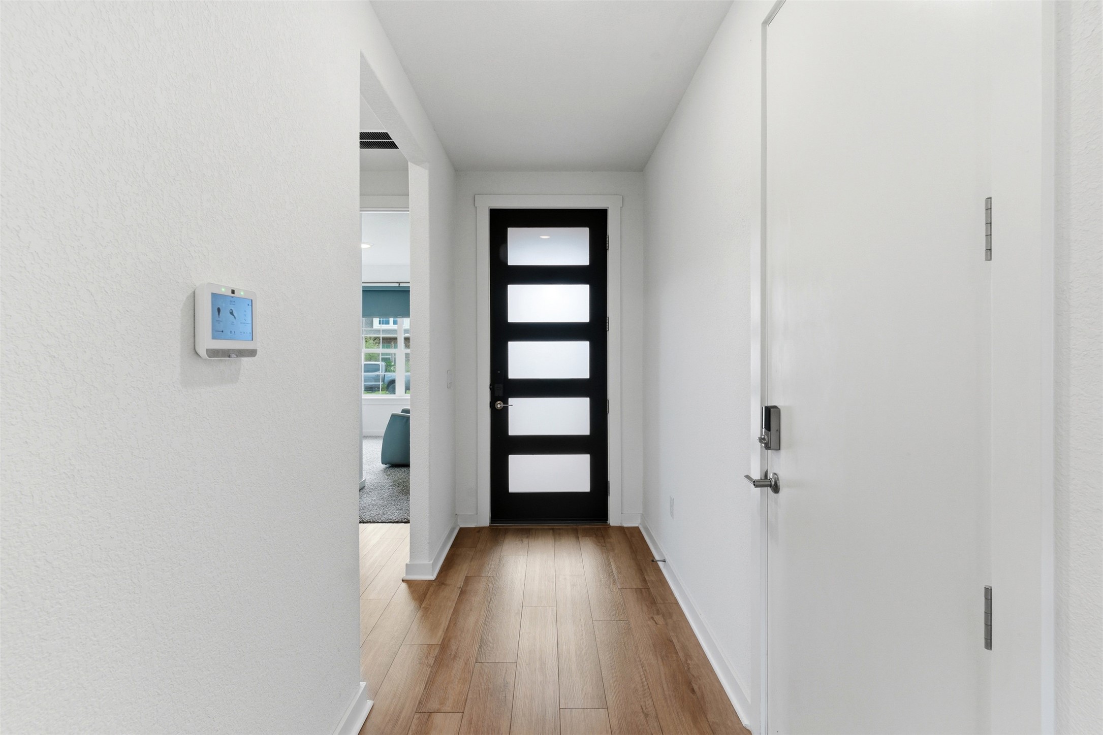 105 Nuntree Cove Georgetown, TX 78628 - Photo 4 of 31 a view of a hallway with wooden floor and staircase