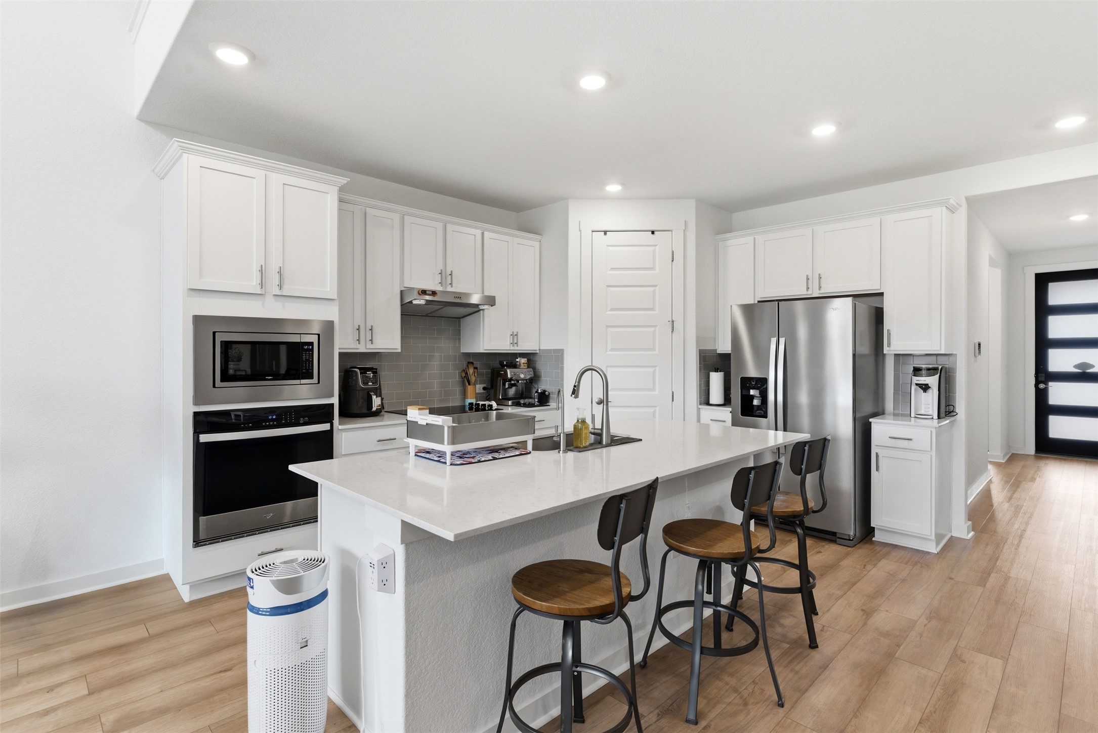 105 Nuntree Cove Georgetown, TX 78628 - Photo 5 of 31 a kitchen with stainless steel appliances a stove a sink a microwave a refrigerator and cabinets